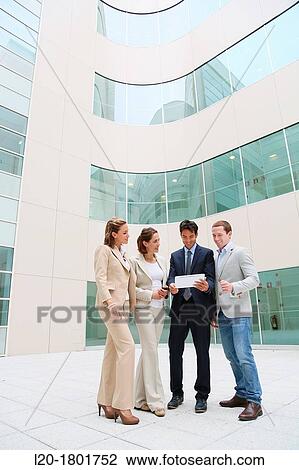 Stock Image - Businesspeople using digital tablet. Fotosearch