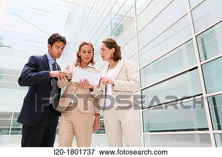 Businesspeople using digital tablet View Large Photo Image Stock Photo - Businesspeople using digital tablet. Fotosearch