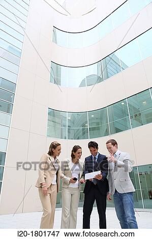 Stock Photo - Businesspeople using digital tablet. Fotosearch
