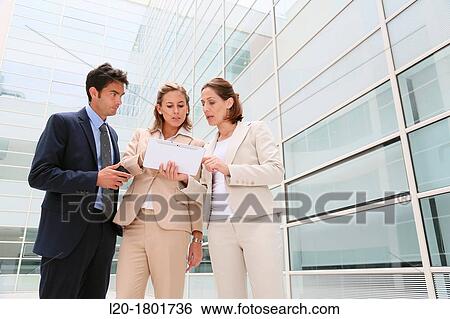 Businesspeople using digital tablet View Large Photo Image Stock Photograph - Businesspeople using digital tablet. Fotosearch