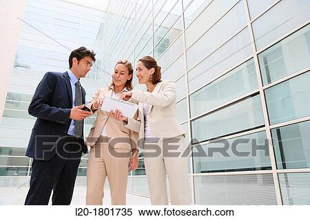 Stock Photography - Businesspeople using digital tablet. Fotosearch