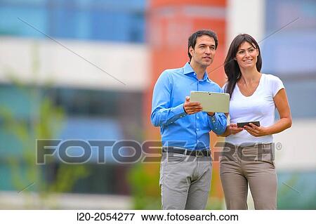 Businesswoman and businessman in business center. San Sebastian Technology Park. Donostia. Gipuzkoa. Basque Country. Spain. View Large Photo Image Stock Photo - Businesswoman and businessman in business center. San Sebastian Technology Park. Donostia. Gipuzkoa. Basque Country. Spain.. Fotosearch