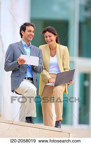 Businesswoman and businessman in business center. San Sebastian Technology Park. Donostia. Gipuzkoa. Basque Country. Spain. View Large Photo Image Stock Photo - Businesswoman and businessman in business center. San Sebastian Technology Park. Donostia. Gipuzkoa. Basque Country. Spain.. Fotosearch