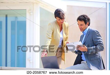 Businesswoman and businessman in business center. San Sebastian Technology Park. Donostia. Gipuzkoa. Basque Country. Spain. View Large Photo Image Stock Photo - Businesswoman and businessman in business center. San Sebastian Technology Park. Donostia. Gipuzkoa. Basque Country. Spain.. Fotosearch