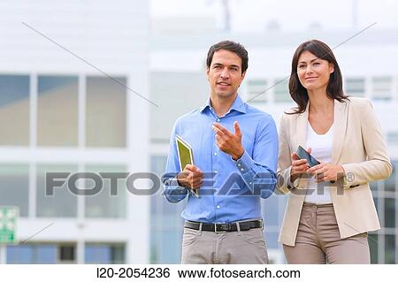 Businesswoman and businessman in business center. San Sebastian Technology Park. Donostia. Gipuzkoa. Basque Country. Spain. View Large Photo Image Stock Photograph - Businesswoman and businessman in business center. San Sebastian Technology Park. Donostia. Gipuzkoa. Basque Country. Spain.. Fotosearch