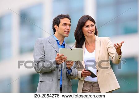 Businesswoman and businessman in business center. San Sebastian Technology Park. Donostia. Gipuzkoa. Basque Country. Spain. View Large Photo Image Stock Photograph - Businesswoman and businessman in business center. San Sebastian Technology Park. Donostia. Gipuzkoa. Basque Country. Spain.. Fotosearch