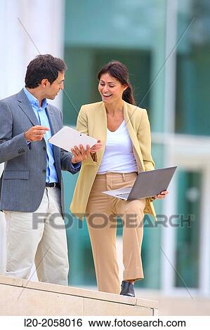 Businesswoman and businessman in business center. San Sebastian Technology Park. Donostia. Gipuzkoa. Basque Country. Spain. View Large Photo Image Stock Photograph - Businesswoman and businessman in business center. San Sebastian Technology Park. Donostia. Gipuzkoa. Basque Country. Spain.. Fotosearch