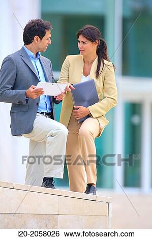 Businesswoman and businessman in business center. San Sebastian Technology Park. Donostia. Gipuzkoa. Basque Country. Spain. View Large Photo Image Stock Photograph - Businesswoman and businessman in business center. San Sebastian Technology Park. Donostia. Gipuzkoa. Basque Country. Spain.. Fotosearch
