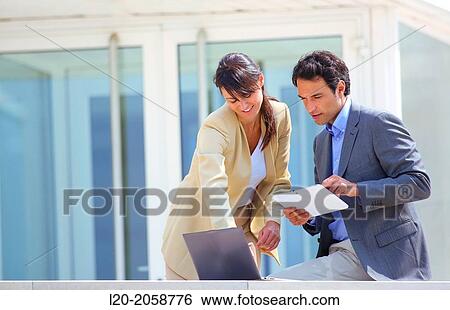 Businesswoman and businessman in business center. San Sebastian Technology Park. Donostia. Gipuzkoa. Basque Country. Spain. View Large Photo Image Stock Photograph - Businesswoman and businessman in business center. San Sebastian Technology Park. Donostia. Gipuzkoa. Basque Country. Spain.. Fotosearch