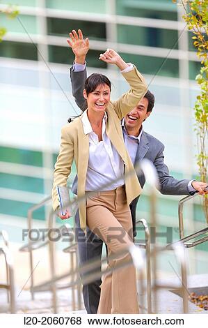 Businesswoman and businessman jumping on stairs. business center. San Sebastian Technology Park. Donostia. Gipuzkoa. Basque Country. Spain. View Large Photo Image Stock Photo - Businesswoman and businessman jumping on stairs. business center. San Sebastian Technology Park. Donostia. Gipuzkoa. Basque Country. Spain.. Fotosearch