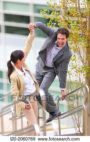 Businesswoman and businessman jumping on stairs. business center. San Sebastian Technology Park. Donostia. Gipuzkoa. Basque Country. Spain. View Large Photo Image Stock Photo - Businesswoman and businessman jumping on stairs. business center. San Sebastian Technology Park. Donostia. Gipuzkoa. Basque Country. Spain.. Fotosearch