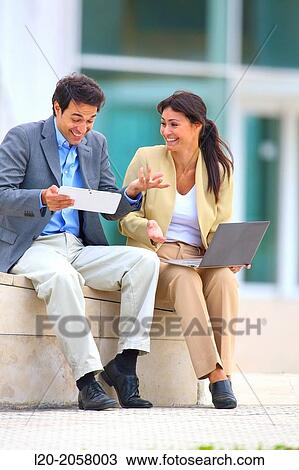 Businesswoman and businessman sitting on business center. San Sebastian Technology Park. Donostia. Gipuzkoa. Basque Country. Spain View Large Photo Image Stock Image - Businesswoman and businessman sitting on business center. San Sebastian Technology Park. Donostia. Gipuzkoa. Basque Country. Spain. Fotosearch