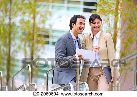 Picture - Businesswoman and businessman talking on stairs. business center. San Sebastian Technology Park. Donostia. Gipuzkoa. Basque Country. Spain.. Fotosearch