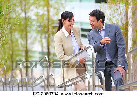 Businesswoman and businessman talking on stairs. business center. San Sebastian Technology Park. Donostia. Gipuzkoa. Basque Country. Spain. View Large Photo Image Picture - Businesswoman and businessman talking on stairs. business center. San Sebastian Technology Park. Donostia. Gipuzkoa. Basque Country. Spain.. Fotosearch