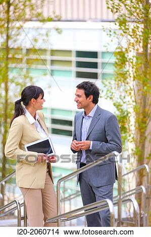 Picture - Businesswoman and businessman talking on stairs. business center. San Sebastian Technology Park. Donostia. Gipuzkoa. Basque Country. Spain.. Fotosearch