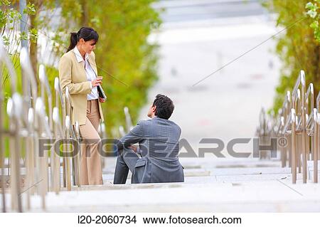 Businesswoman and businessman talking on stairs. business center. San Sebastian Technology Park. Donostia. Gipuzkoa. Basque Country. Spain. View Large Photo Image Picture - Businesswoman and businessman talking on stairs. business center. San Sebastian Technology Park. Donostia. Gipuzkoa. Basque Country. Spain.. Fotosearch