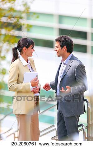 Stock Image - Businesswoman and businessman talking on stairs. business center. San Sebastian Technology Park. Donostia. Gipuzkoa. Basque Country. Spain.. Fotosearch