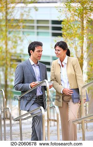 Businesswoman and businessman talking on stairs. business center. San Sebastian Technology Park. Donostia. Gipuzkoa. Basque Country. Spain. View Large Photo Image Stock Photo - Businesswoman and businessman talking on stairs. business center. San Sebastian Technology Park. Donostia. Gipuzkoa. Basque Country. Spain.. Fotosearch