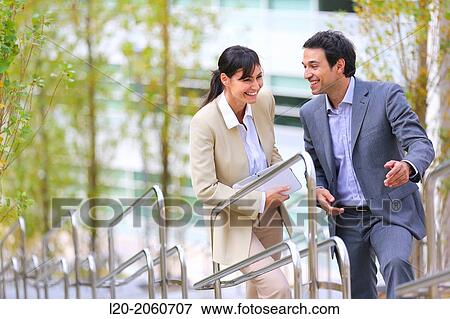 Stock Photo - Businesswoman and businessman talking on stairs. business center. San Sebastian Technology Park. Donostia. Gipuzkoa. Basque Country. Spain.. Fotosearch