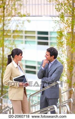 Stock Photo - Businesswoman and businessman talking on stairs. business center. San Sebastian Technology Park. Donostia. Gipuzkoa. Basque Country. Spain.. Fotosearch