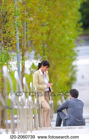Businesswoman and businessman talking on stairs. business center. San Sebastian Technology Park. Donostia. Gipuzkoa. Basque Country. Spain. View Large Photo Image Stock Photo - Businesswoman and businessman talking on stairs. business center. San Sebastian Technology Park. Donostia. Gipuzkoa. Basque Country. Spain.. Fotosearch