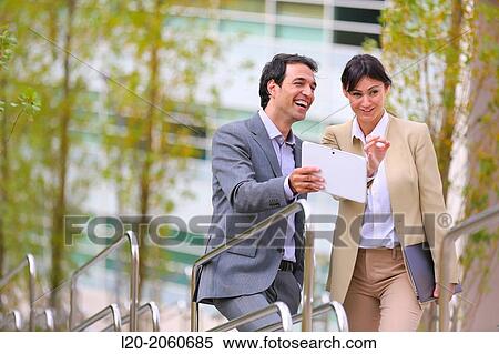 Businesswoman and businessman talking on stairs. business center. San Sebastian Technology Park. Donostia. Gipuzkoa. Basque Country. Spain. View Large Photo Image Stock Photography - Businesswoman and businessman talking on stairs. business center. San Sebastian Technology Park. Donostia. Gipuzkoa. Basque Country. Spain.. Fotosearch