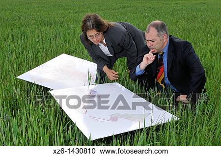 businesswoman and businessman with blueprints in the field View Large Photo Image Stock Image - businesswoman and businessman with blueprints in the field. Fotosearch