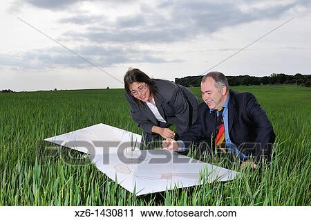 businesswoman and businessman with blueprints in the field View Large Photo Image Stock Image - businesswoman and businessman with blueprints in the field. Fotosearch