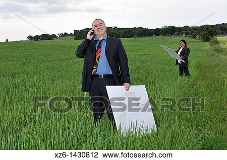 businesswoman and businessman with blueprints in the field View Large Photo Image Stock Image - businesswoman and businessman with blueprints in the field. Fotosearch