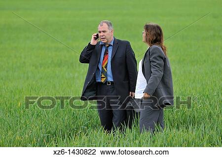 businesswoman and businessman with mobile phone in the field View Large Photo Image Stock Image - businesswoman and businessman with mobile phone in the field. Fotosearch