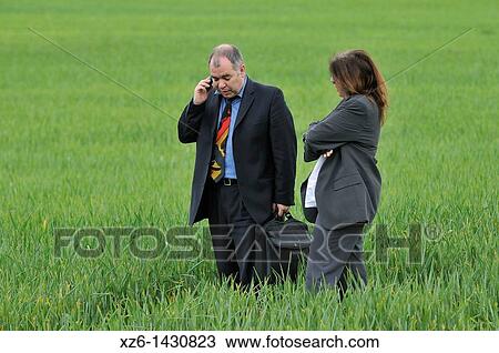 businesswoman and businessman with mobile phone in the field View Large Photo Image Stock Image - businesswoman and businessman with mobile phone in the field. Fotosearch