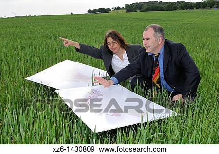 businesswoman and businessman with blueprints in the field View Large Photo Image Stock Photo - businesswoman and businessman with blueprints in the field. Fotosearch