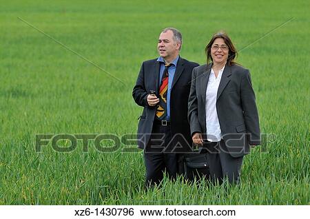 businesswoman and businessman with mobile phone in the field View Large Photo Image Stock Photograph - businesswoman and businessman with mobile phone in the field. Fotosearch