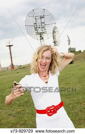 Stock Photo - Businesswoman anger with the celular. Fotosearch