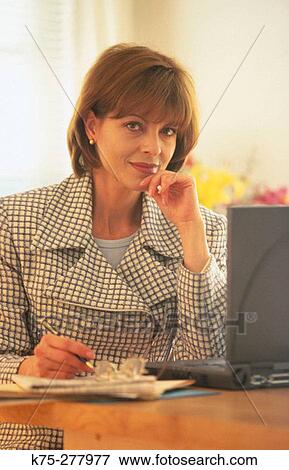 Businesswoman at her desk View Large Photo Image Stock Photo - Businesswoman at her desk. Fotosearch