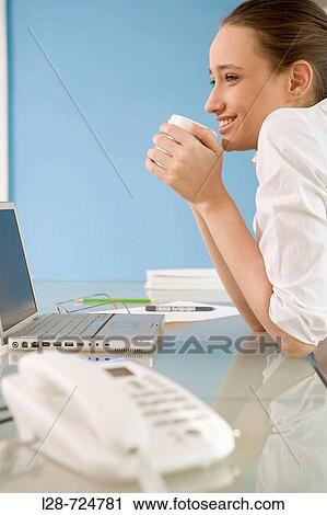 businesswoman by laptop holding cup, portrait View Large Photo Image Stock Image - businesswoman by laptop holding cup, portrait. Fotosearch