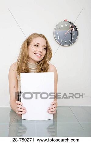 Stock Image - Businesswoman holding blank paper. Fotosearch