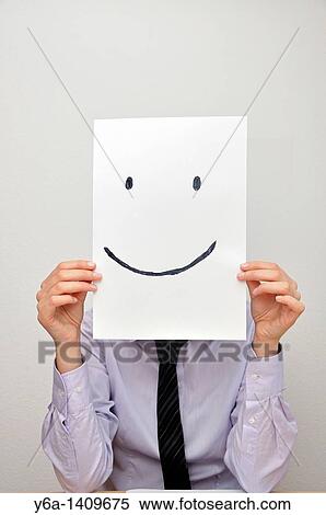 Businesswoman holding card with smiley face in front of face View Large Photo Image Stock Photography - Businesswoman holding card with smiley face in front of face. Fotosearch