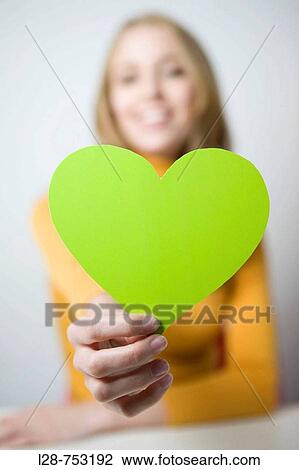 Businesswoman holding cut-out heart View Large Photo Image Stock Image - Businesswoman holding cut-out heart. Fotosearch