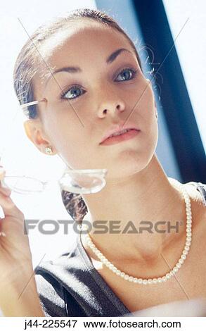 Businesswoman holding glasses View Large Photo Image Stock Photo - Businesswoman holding glasses. Fotosearch