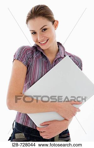 Businesswoman holding laptop, smiling, portrait View Large Photo Image Picture - Businesswoman holding laptop, smiling, portrait. Fotosearch