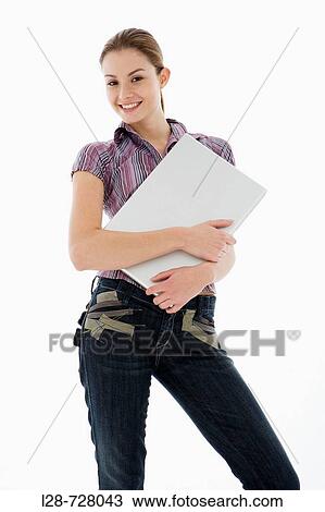 Businesswoman holding laptop, smiling, portrait View Large Photo Image Stock Image - Businesswoman holding laptop, smiling, portrait. Fotosearch