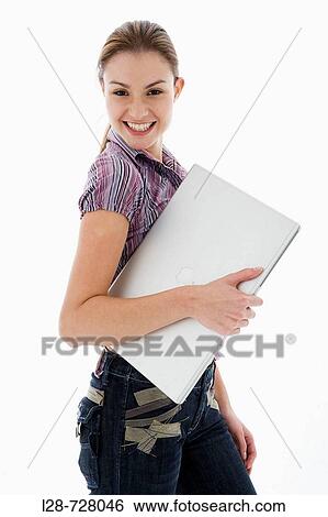 Businesswoman holding laptop, smiling, portrait View Large Photo Image Stock Photograph - Businesswoman holding laptop, smiling, portrait. Fotosearch