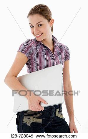 Stock Photography - Businesswoman holding laptop, smiling, portrait. Fotosearch