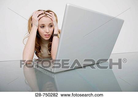 Stock Image - businesswoman looking at computer. Fotosearch