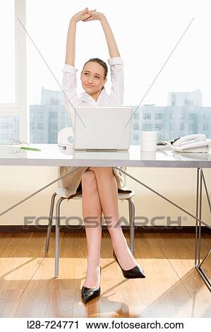 Businesswoman stretching at desk View Large Photo Image Stock Image - Businesswoman stretching at desk. Fotosearch