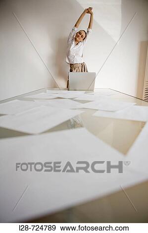 Businesswoman stretching at desk View Large Photo Image Stock Photo - Businesswoman stretching at desk. Fotosearch