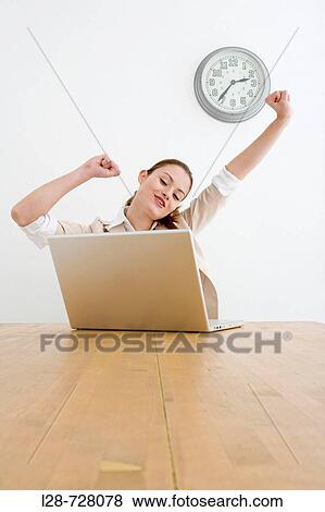 Businesswoman stretching at desk View Large Photo Image Stock Photo - Businesswoman stretching at desk. Fotosearch
