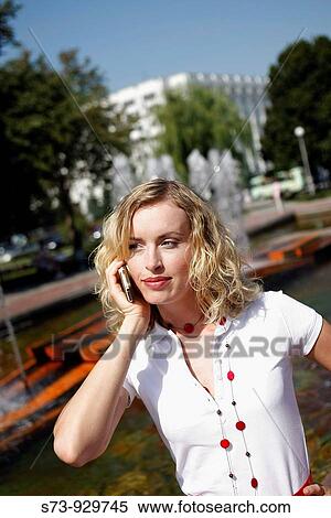 Stock Photography - Businesswoman using cell phone. Fotosearch