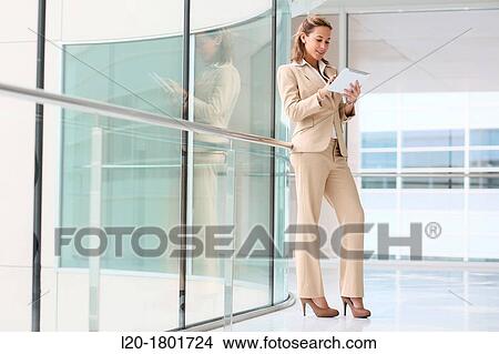 Businesswoman using digital tablet View Large Photo Image Picture - Businesswoman using digital tablet. Fotosearch